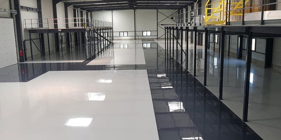 This image shows a warehouse with a white and gray epoxy floor.